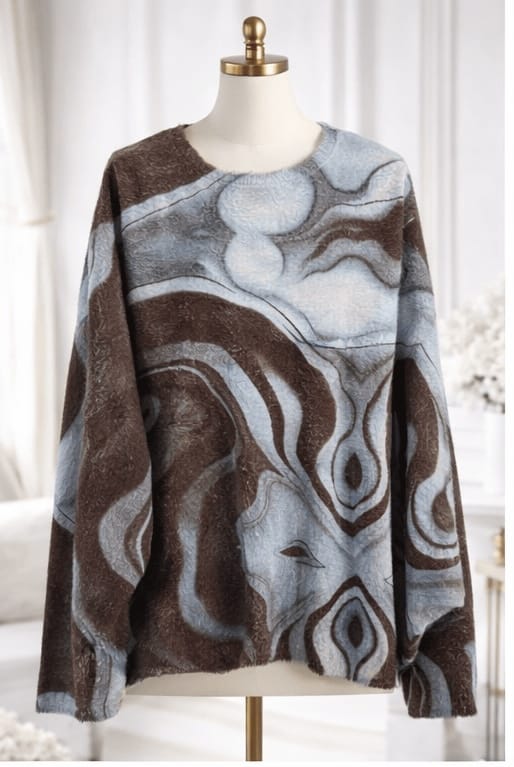 Abstract patterned sweater on a mannequin against a white background