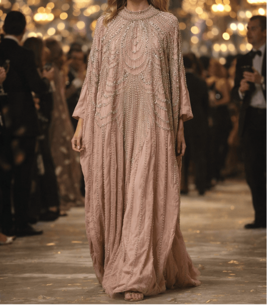 Beige evening gown on a mannequin and worn by a woman in an elegant setting.
