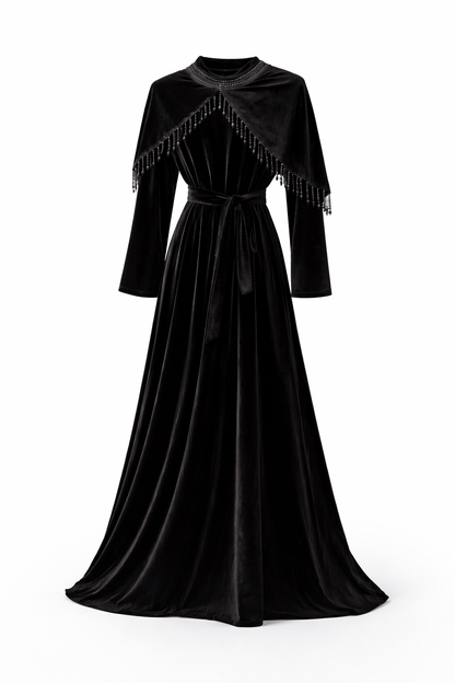 Black velvet dress with fringe details on a white background