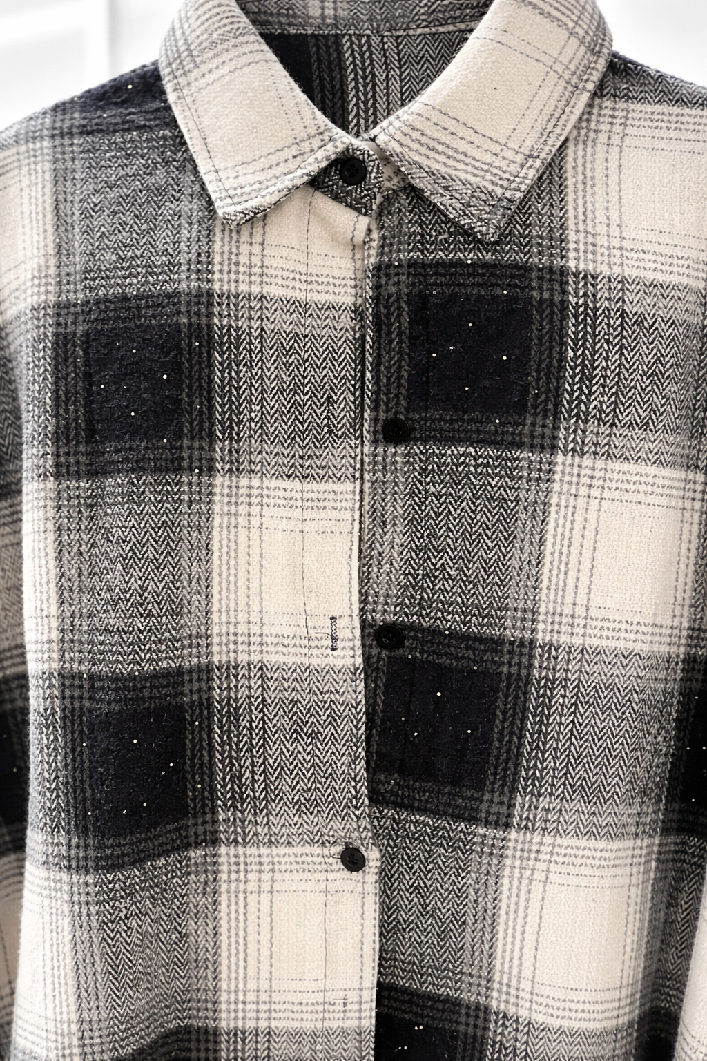 Plaid shirt with a collar and buttons on a plain background