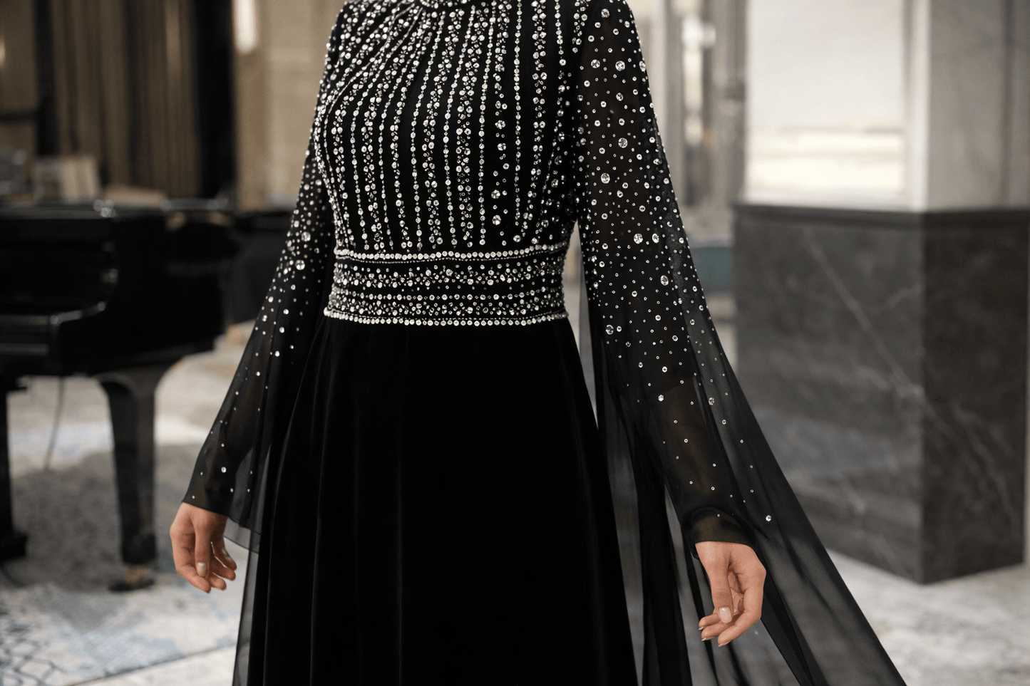 Black evening gown with intricate beading in a room setting