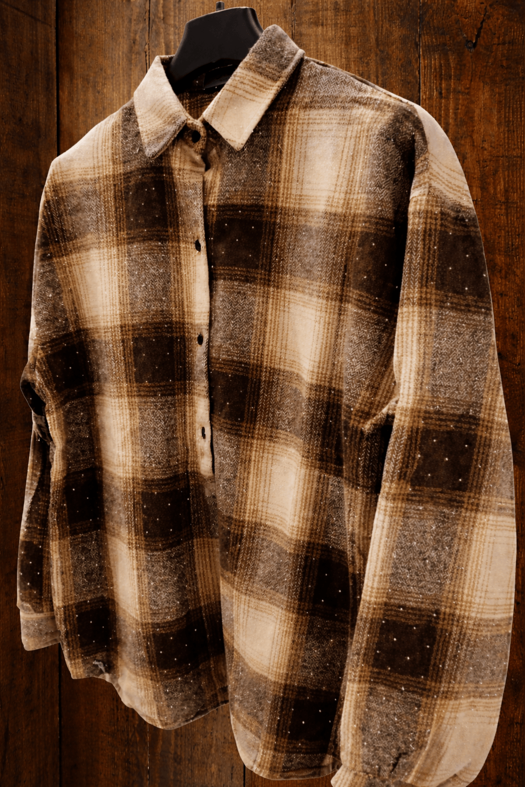 Plaid shirt on a mannequin against a wooden background