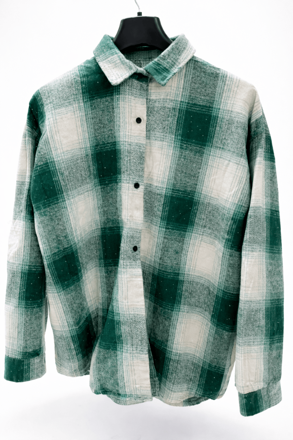 Green and white checkered shirt on a hanger against a white background