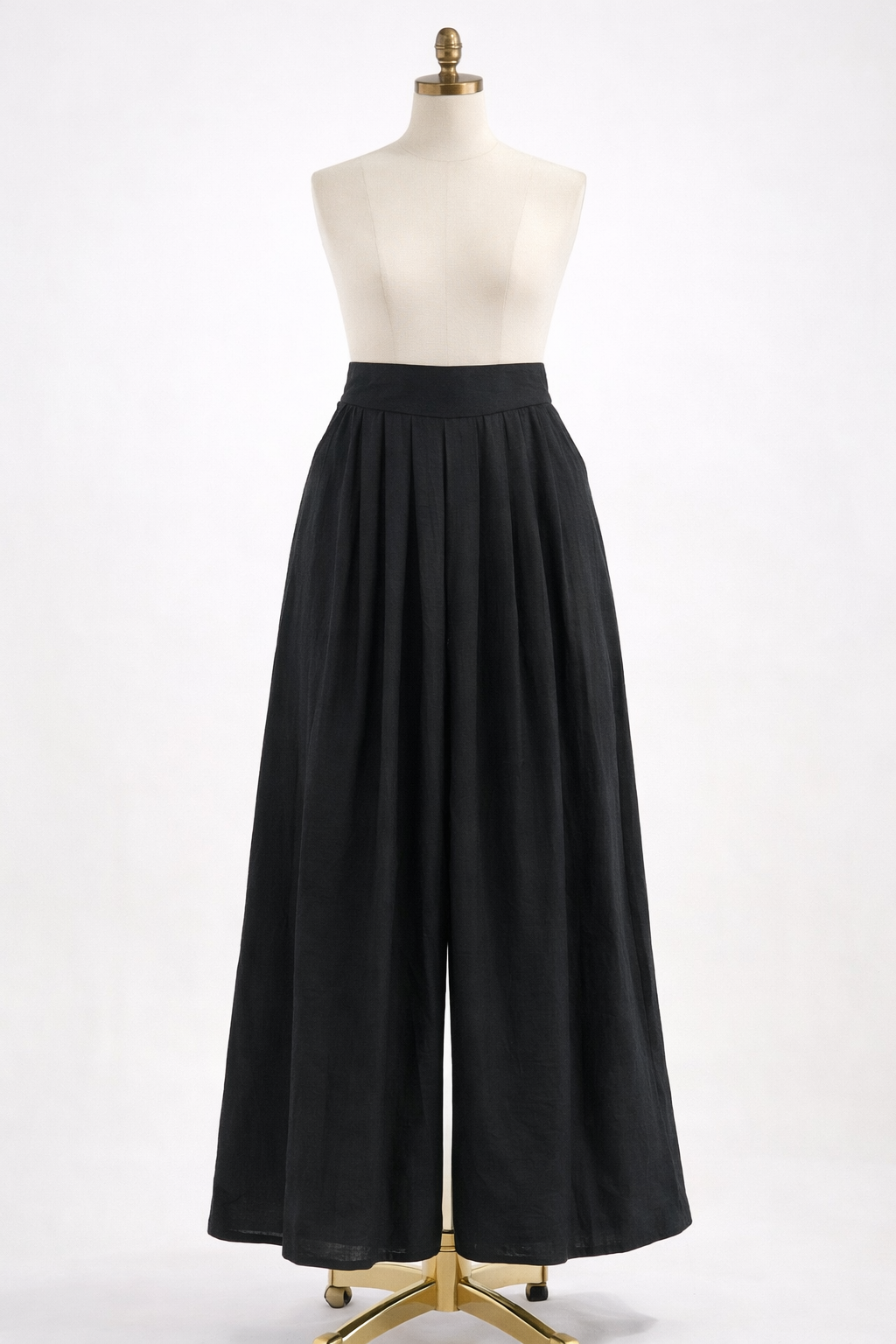 Black wide-leg pants on a mannequin against a white background