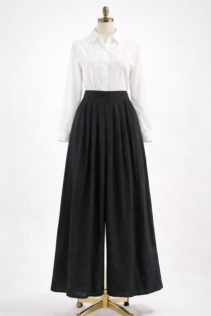 Mannequin wearing a white shirt and black wide-leg pants on a white background