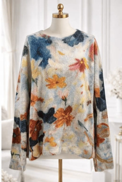 Floral patterned sweater on a mannequin against a white background