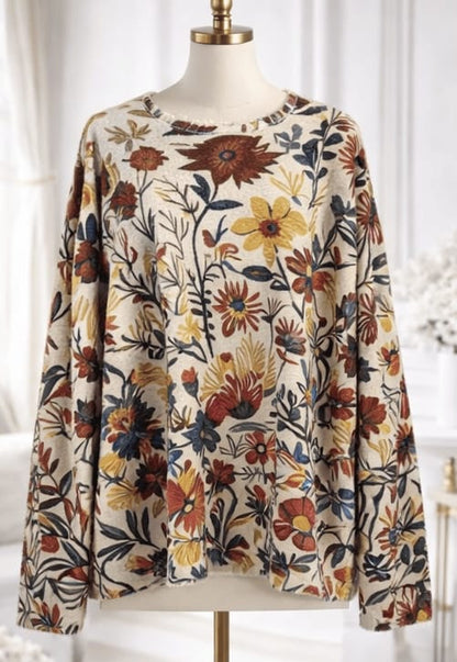 Floral patterned blouse on a mannequin against a white background