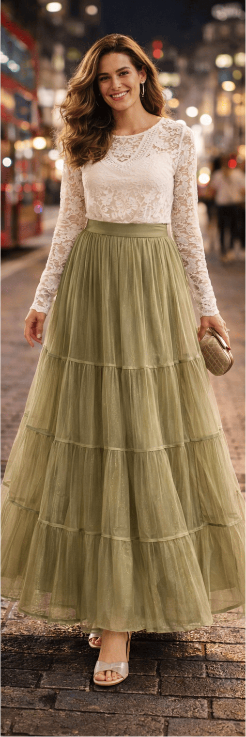 Woman wearing a long, light green tiered skirt with a white lace top on a city street.