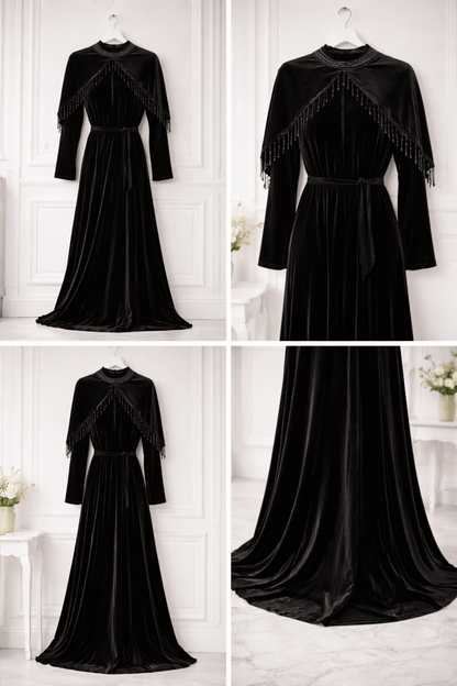 Black evening gown with long sleeves and fringe details on a white background