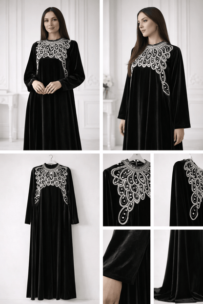 Black dress with intricate silver embroidery on a white background