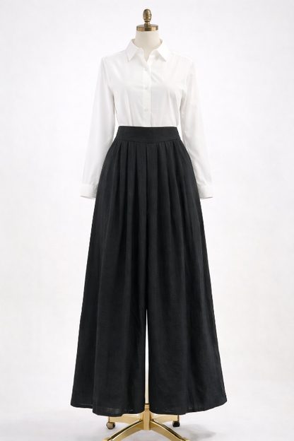 Mannequin wearing a white shirt and black wide-leg pants on a white background