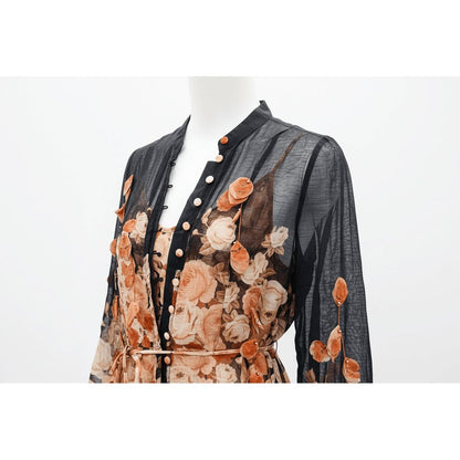 Mannequin wearing a floral patterned outfit with a sheer overlay on a white background