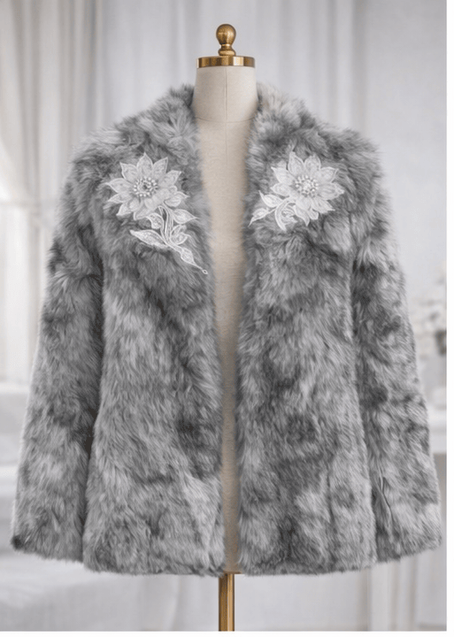 Gray faux fur coat with floral embellishments on a mannequin against a white background