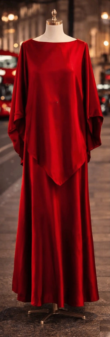 Red evening gown on a mannequin against a blurred city street background