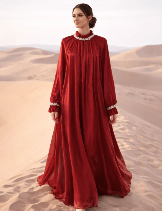 Woman in a red dress standing in a desert landscape