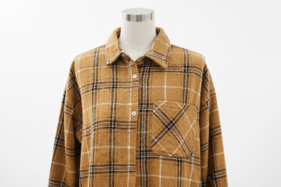 Brown plaid shirt on a mannequin against a white background